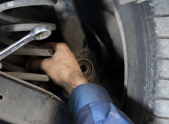 Mechanic repairing the suspension on the car