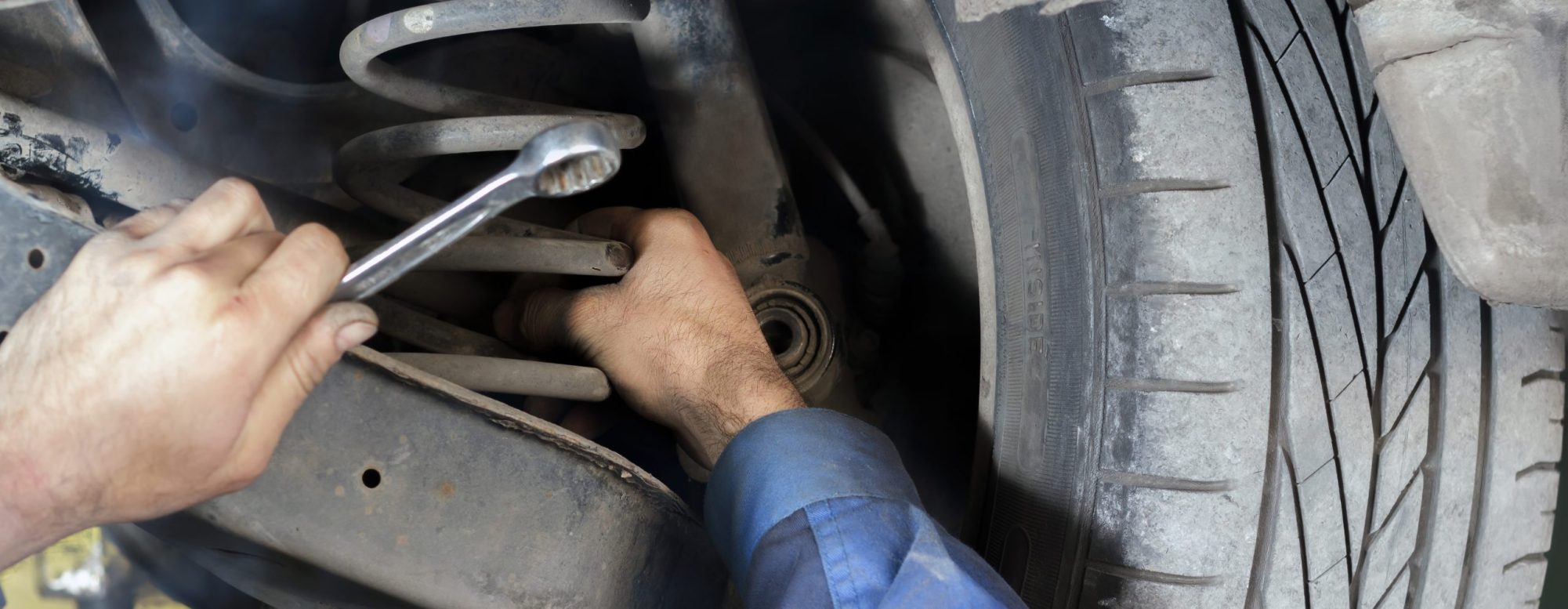 Mechanic repairing the suspension on the car